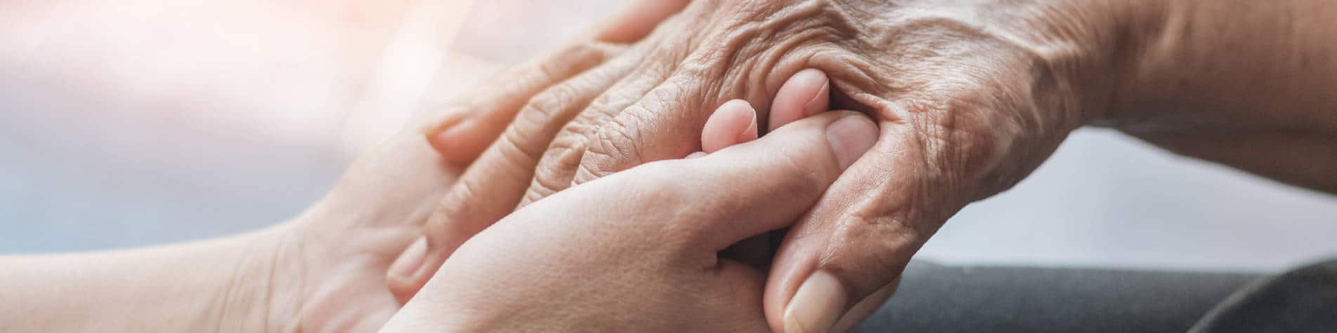 Post-Stroke Care, Young Hands Holding Old Hands