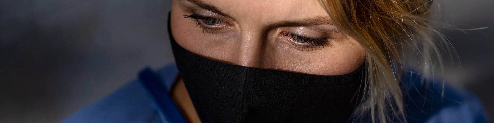 Tired Caregiver Wearing a Face Mask