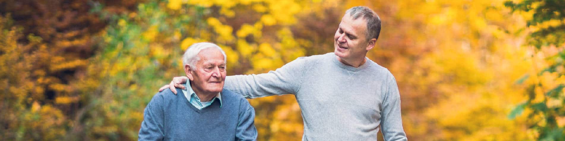 Benefits of Being a Caregiver, Elderly Man and Adult Son Walking Among Fall Trees