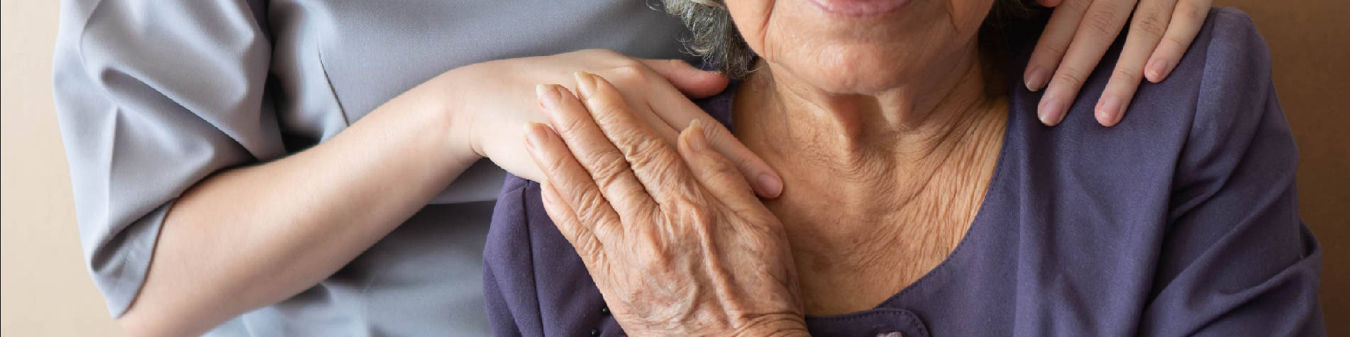 Professional Boundaries for Caregivers, An Caregiver Standing Behind and Elderly Woman, Holding Her Hand