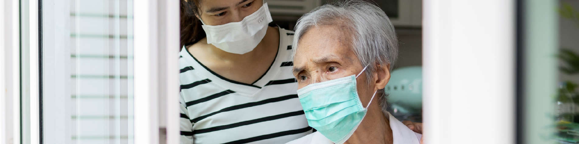 When Siblings Won't Help with Elderly Parents, Elderly Woman Looking Out a Window with Her Family Caregiver Behind Her