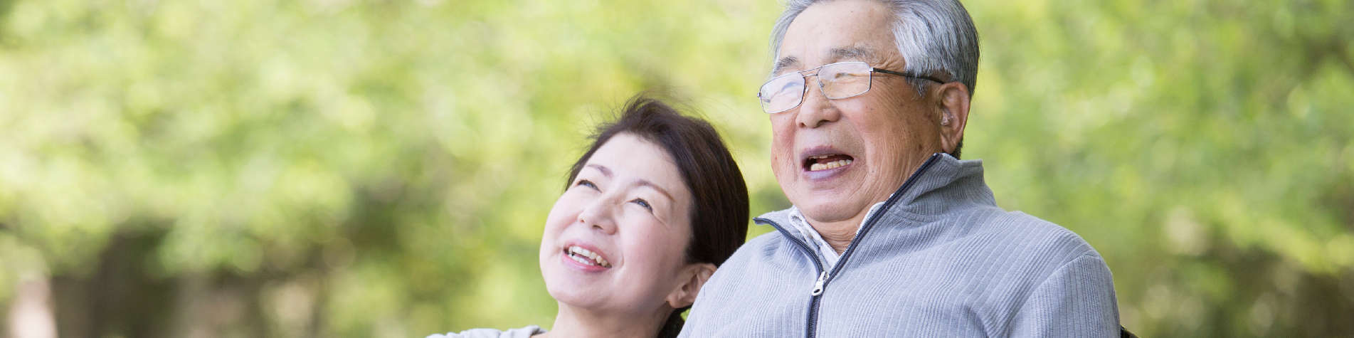 Stages of Caregiving, Woman with an Elderly Man Smiling in a Park