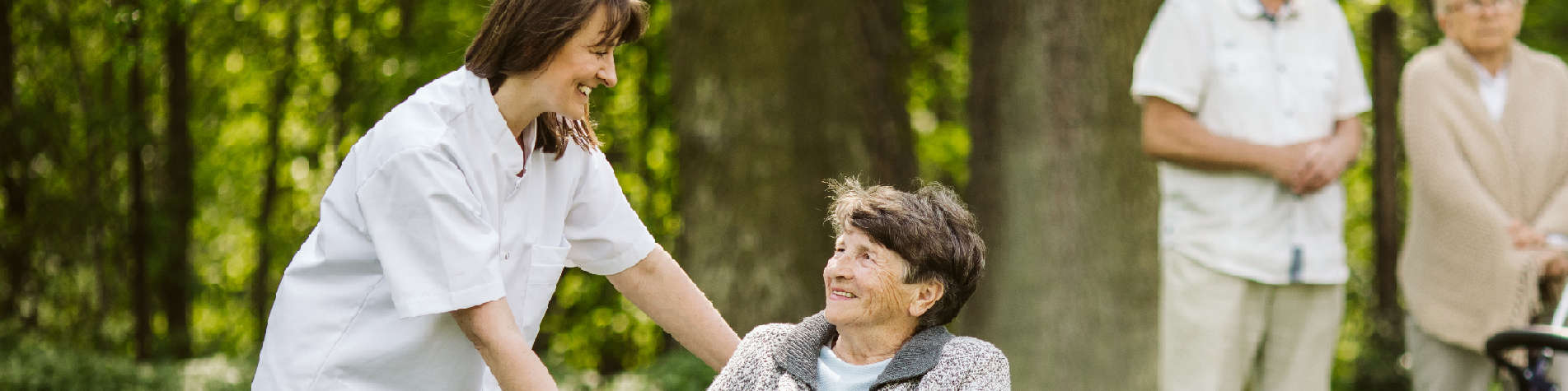 Types of Caregivers, Caregiver with a Group of Clients Out in a Park