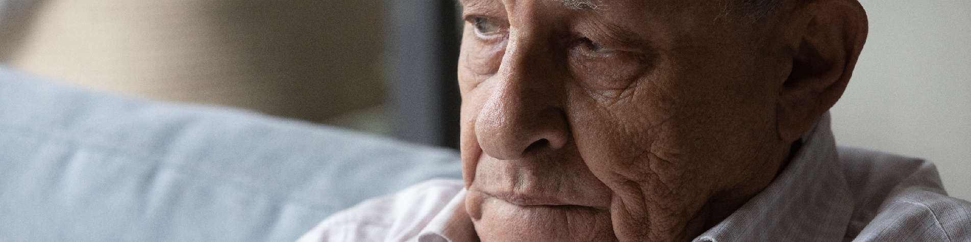 Dementia and Anger at Loved Ones, Closeup of an Elderly Man's Face While He Sits on a Couch